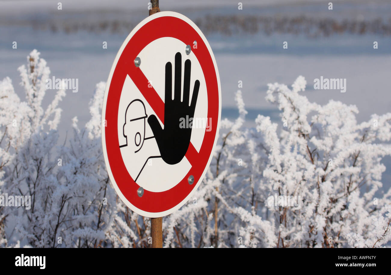 Winter landscape: stop-sign with outstretched black hand ('do not enter') Stock Photo