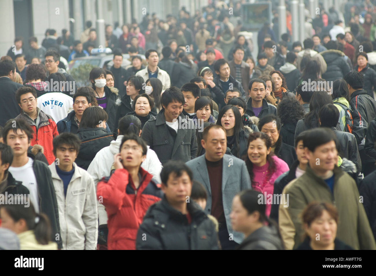 Pollution shrouds a crowd of shoppers in Beijing's Wanfujing shopping district. Stock Photo
