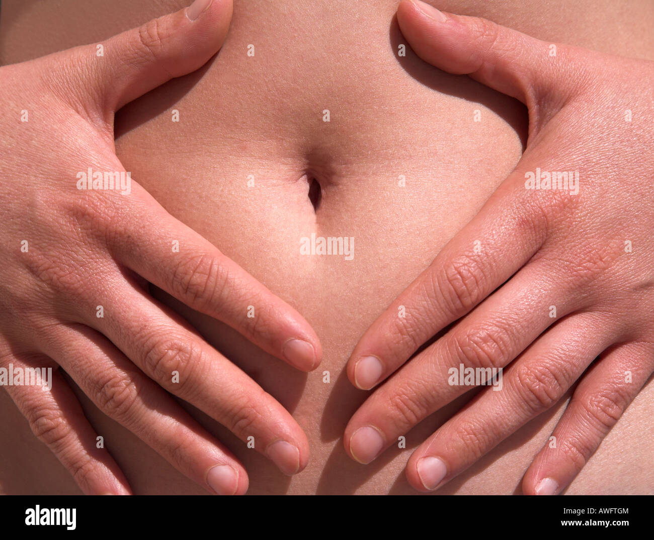 Tummy and hands Stock Photo