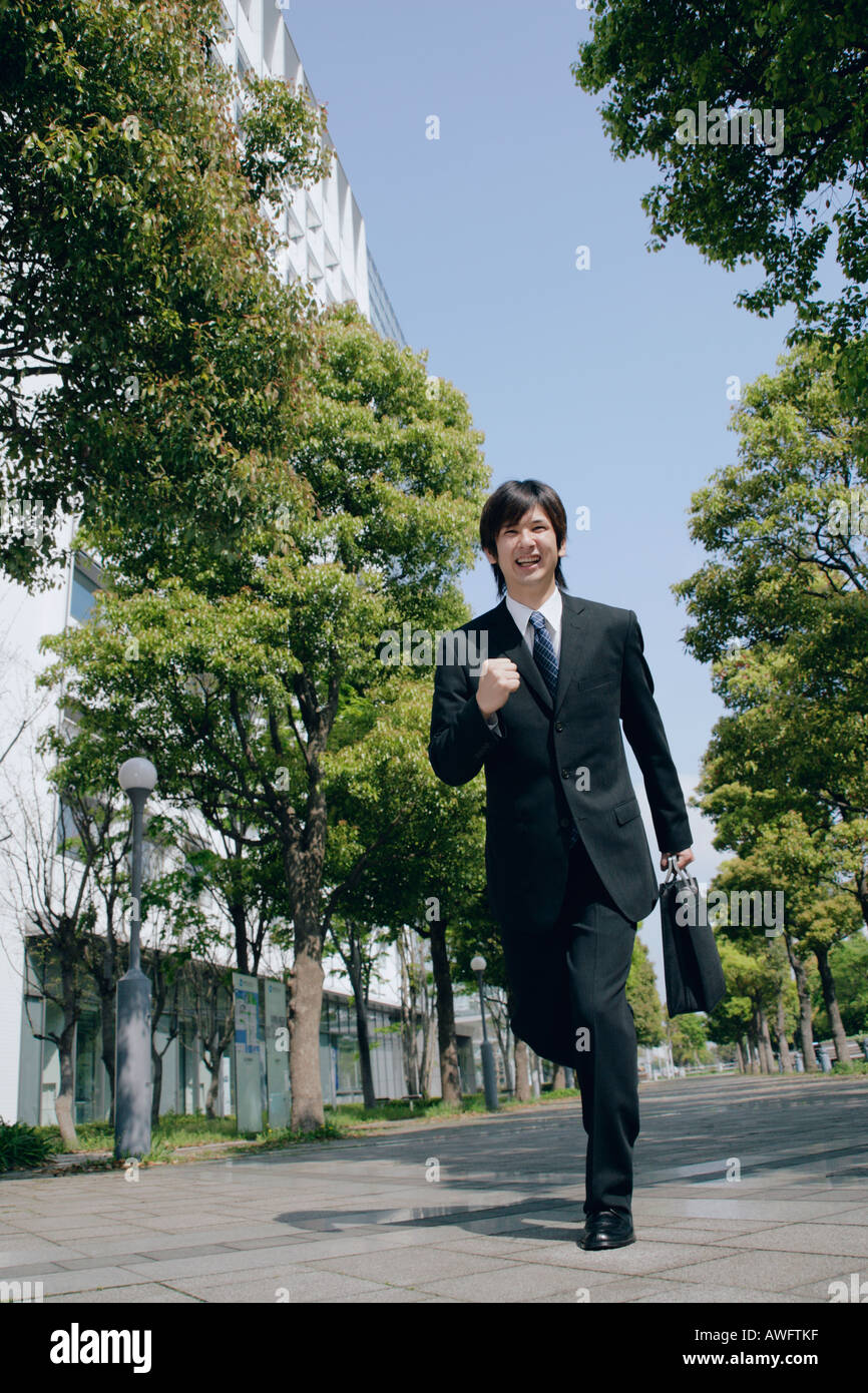 A young man in suit running Stock Photo Alamy