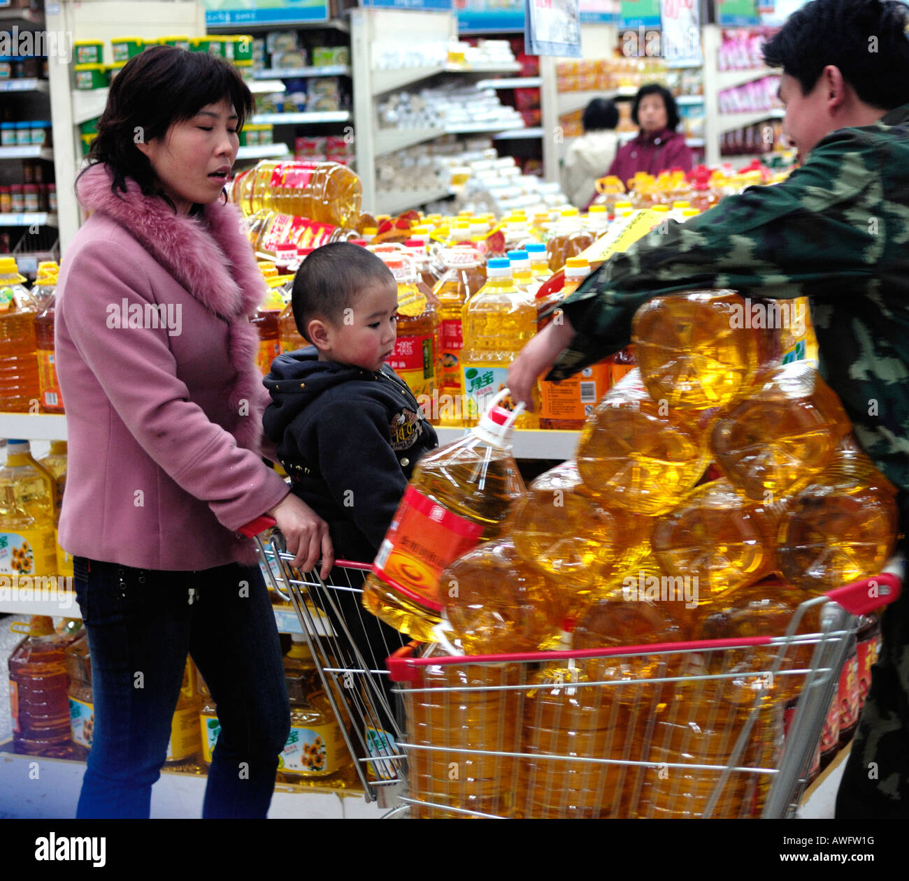 Chinese consumers buy bottle food oil in a supermarket in Beijing China. 12-Mar-2008 Stock Photo