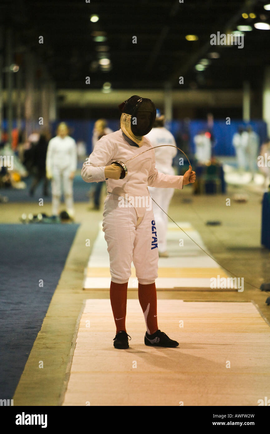 SPORTS Fencing competition woman competitor flexing epee weapon prior
