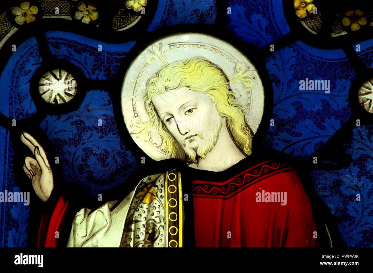 A stained glass window in Gloucester cathedral of Jesus standing by the sea holding his hands up Stock Photo