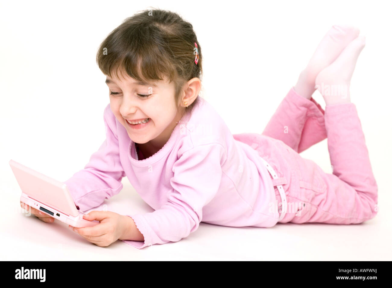 pink dressed girl with pink gameboy Stock Photo