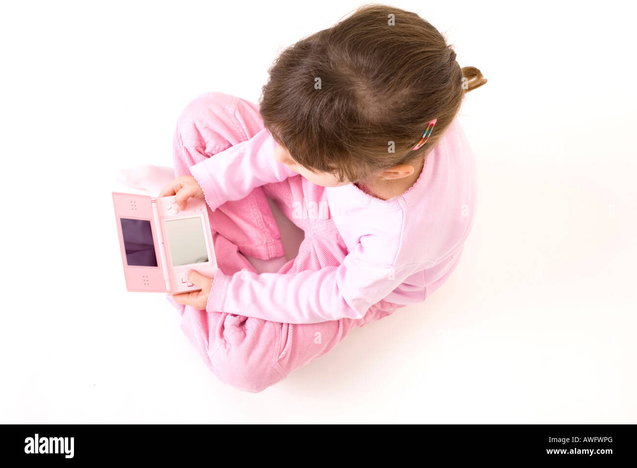 pink dressed girl with pink gameboy Stock Photo