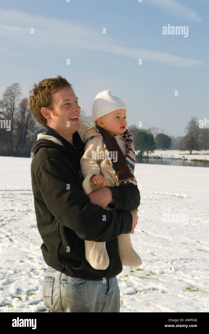 Petworth Park West Sussex UK Snow February Father and one year old son Stock Photo