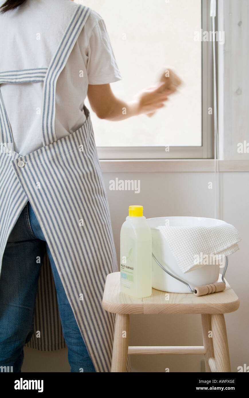 A woman cleaning window, blurred motion Stock Photo