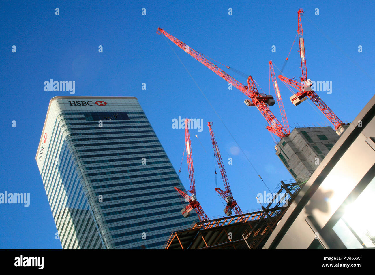 HSBC head office building and construction cranes, Canary Wharf, London