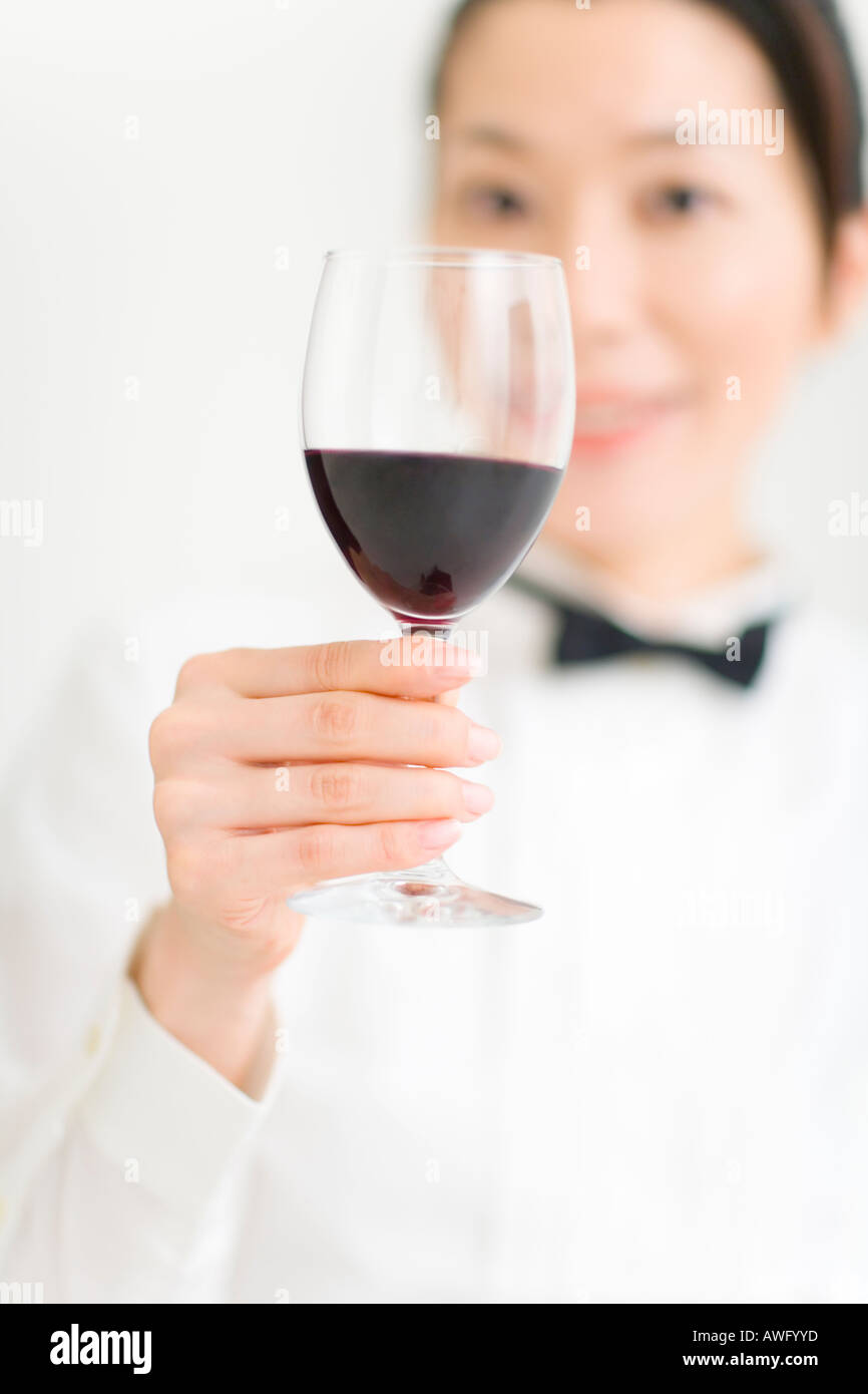 A female sommelier holding a glass of wine Stock Photo