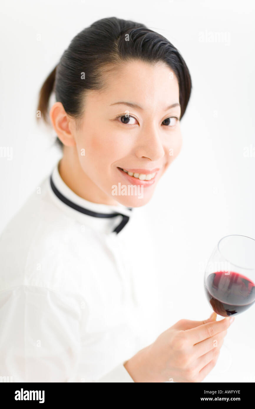 A female sommelier holding a glass of wine Stock Photo