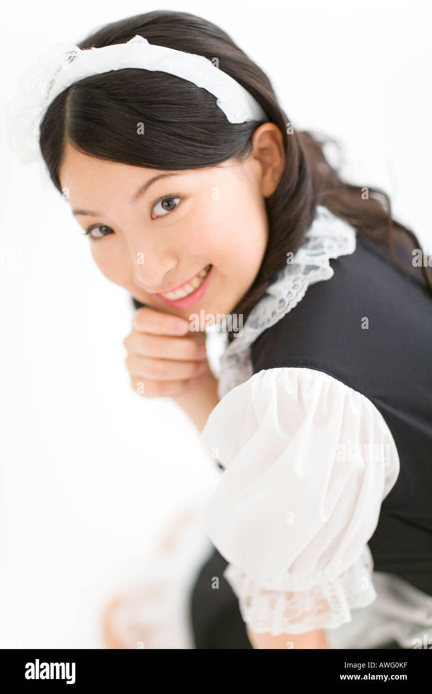 A young woman in French maid outfit smiling Stock Photo