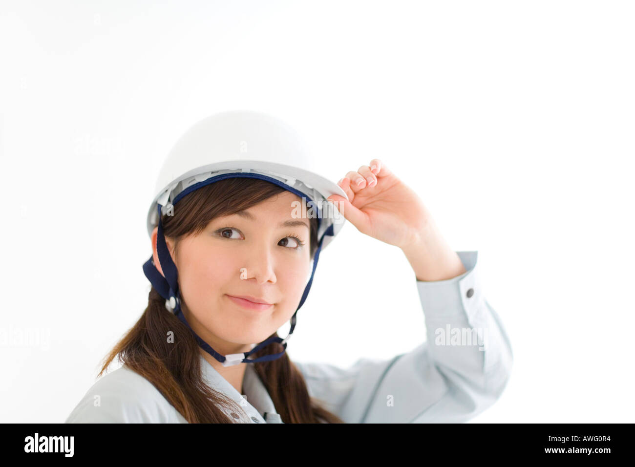 A female construction worker wearing a hardhat Stock Photo