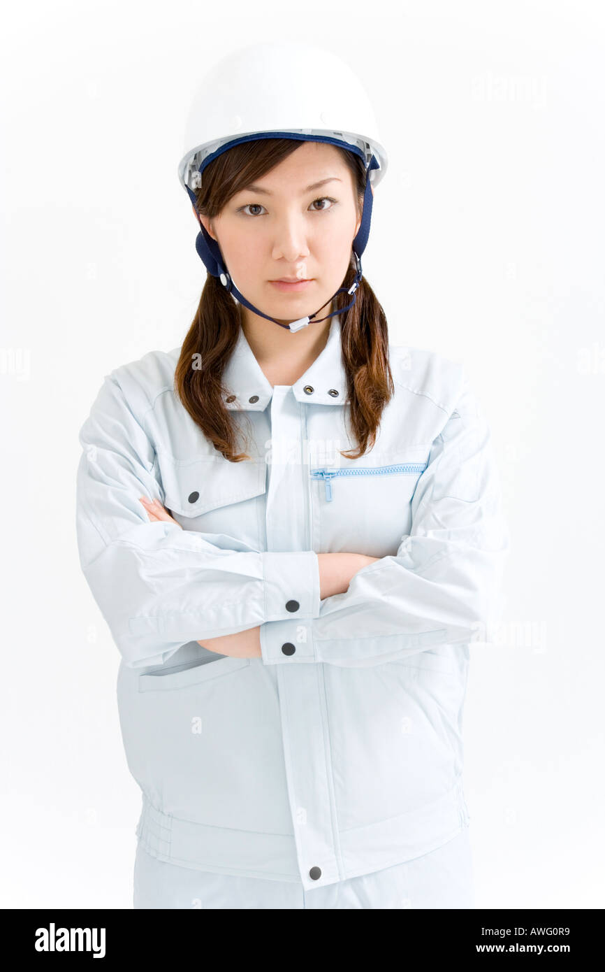 A female construction worker wearing a hardhat Stock Photo