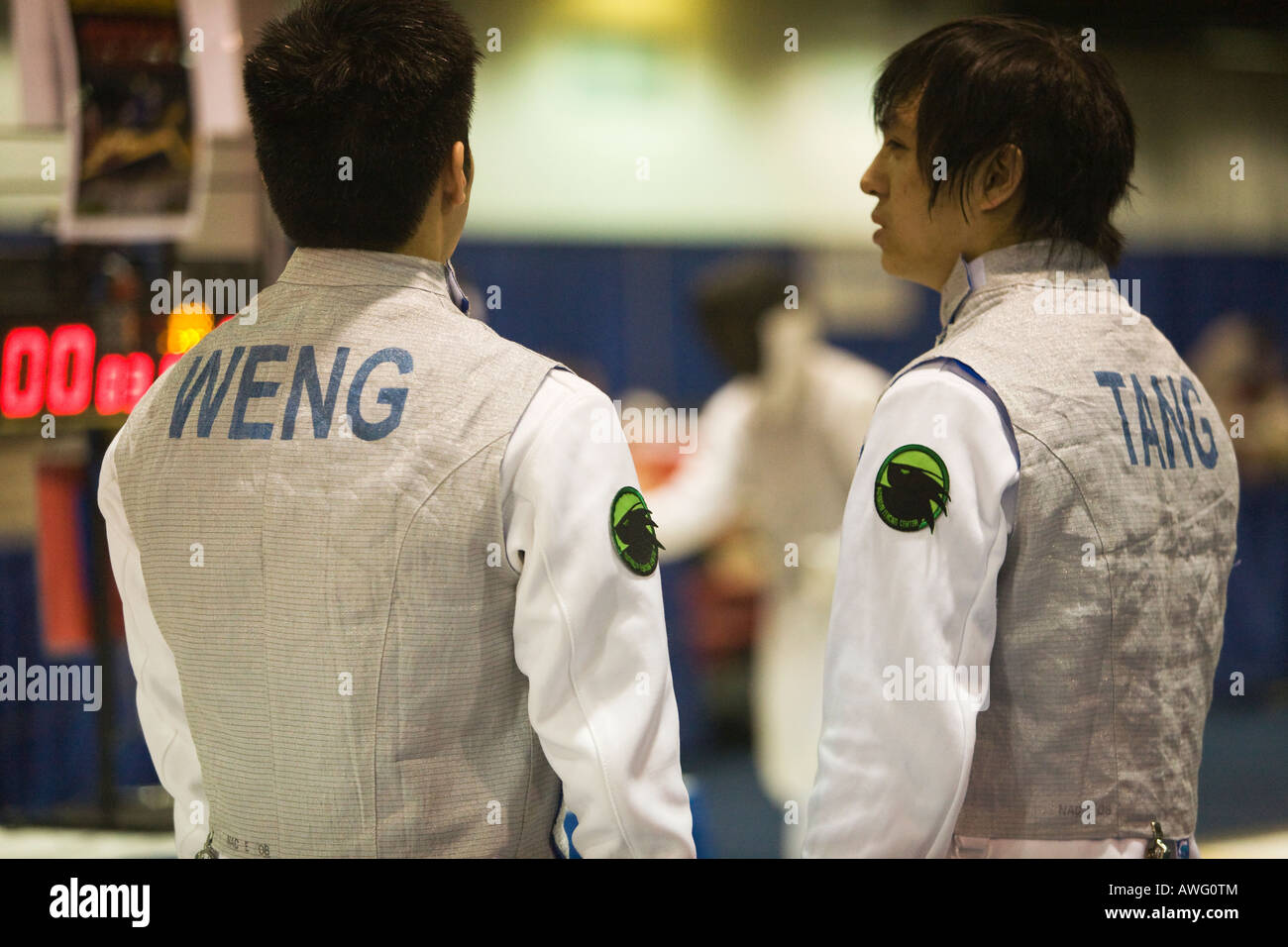 SPORTS Fencing competition two male foil competitors talking on strip prior to match names stenciled on backs Stock Photo