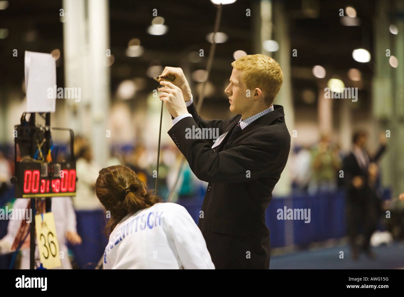 SPORTS Fencing competition male referee check epee weapon prior to