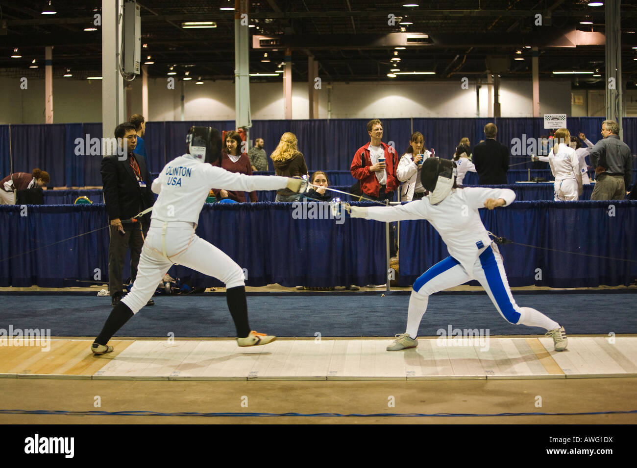 SPORTS Fencing competition referee watching two women competing on