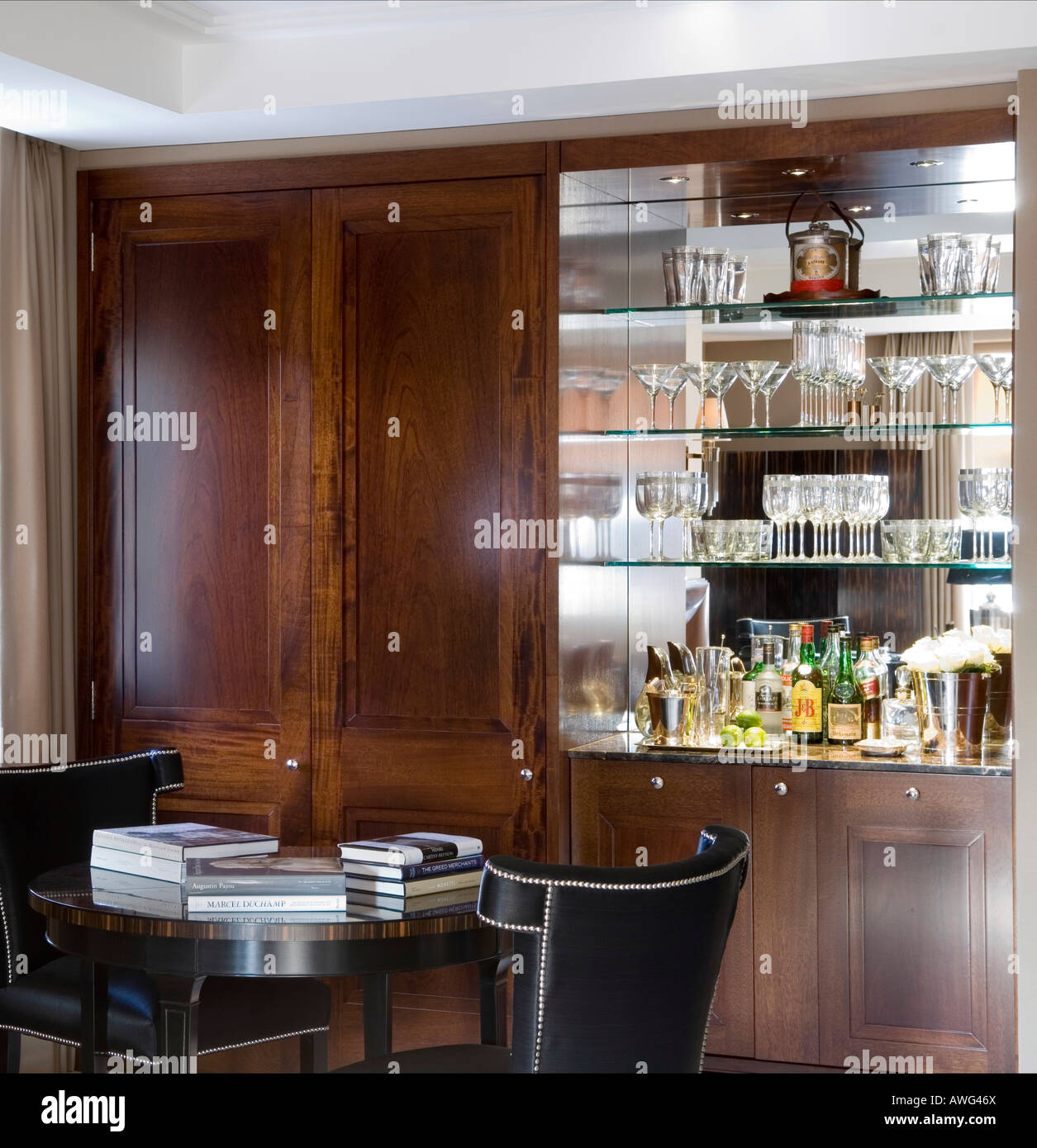 Small Dining Table In Front Of A Drinks Cabinet In A London Stock