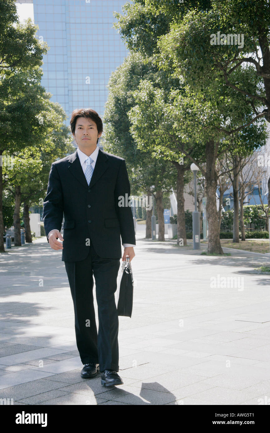 Mid adult businessman walking hi-res stock photography and images - Alamy