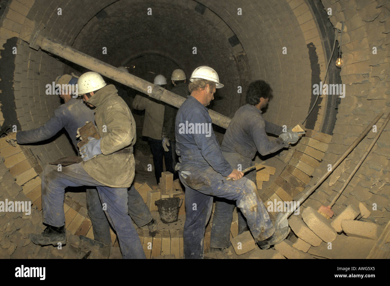 Workers Re lining the kiln at Jelsava magnesite factory in central Slovakia Stock Photo