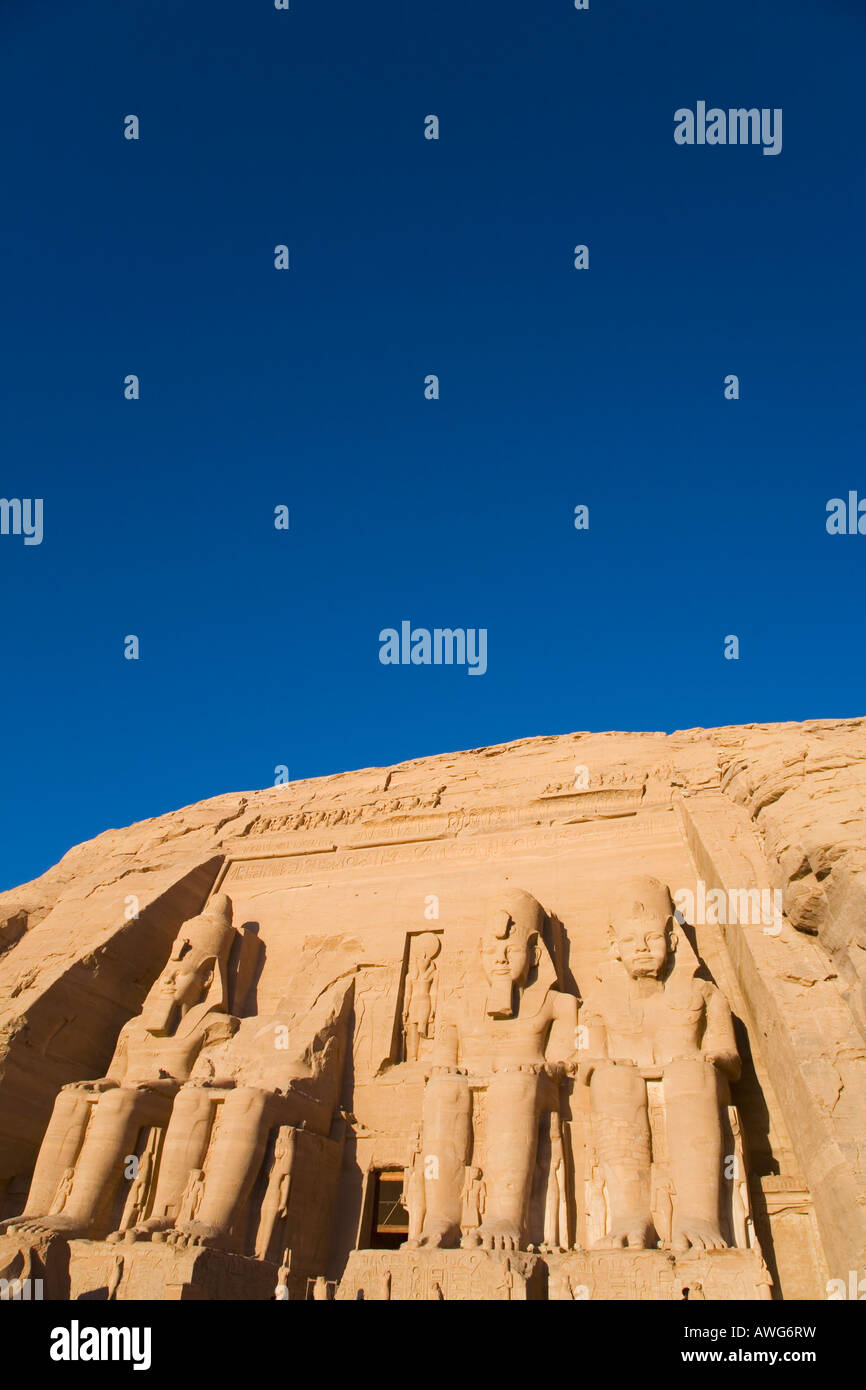 Abu Simbel Temple entrance with statues of Ramses II in early morning sun sunshine Egypt North Africa Stock Photo
