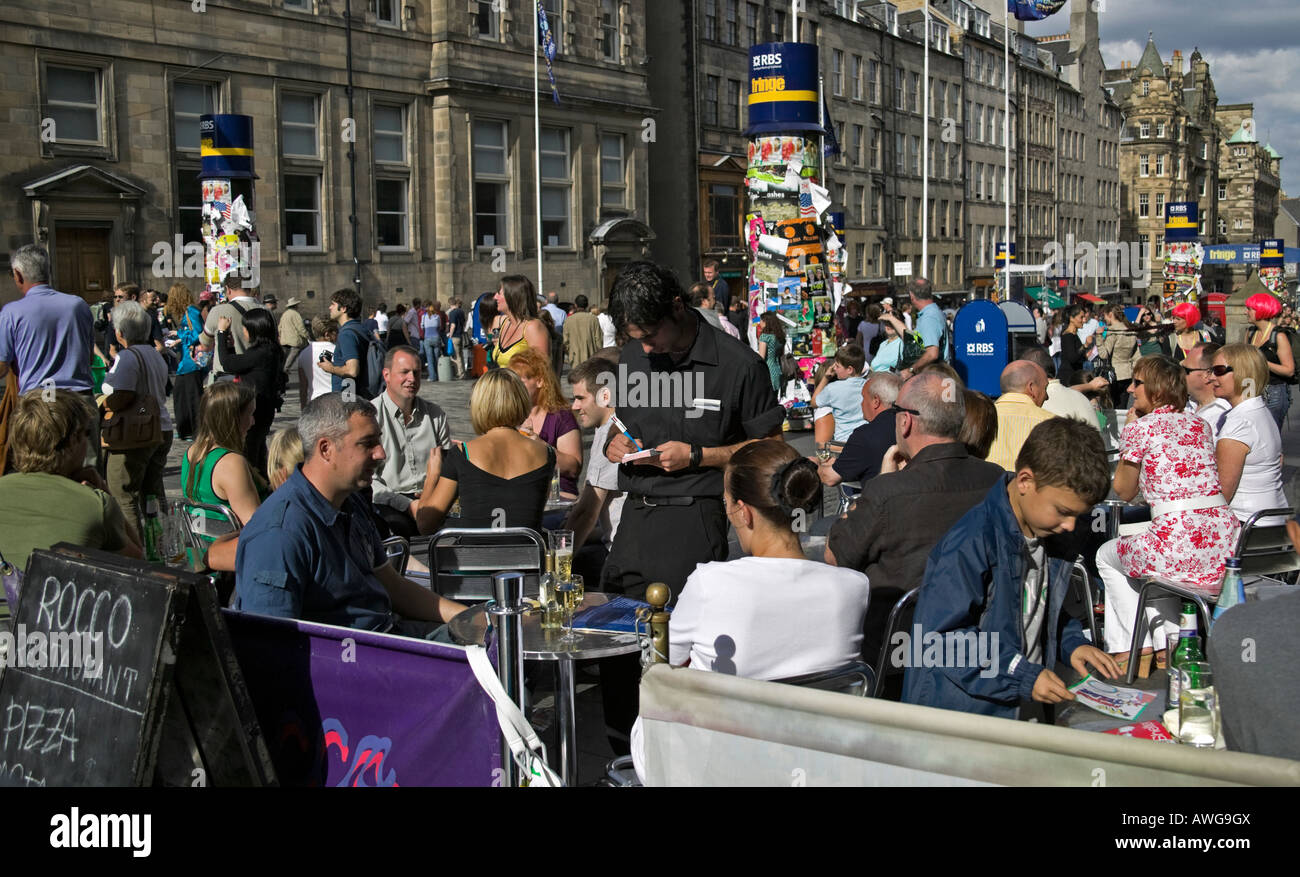 Customers sitting outside at restaurant during Edinburgh Fringe Festival, High Street, Edinburgh, Scotland, UK, Europe Stock Photo