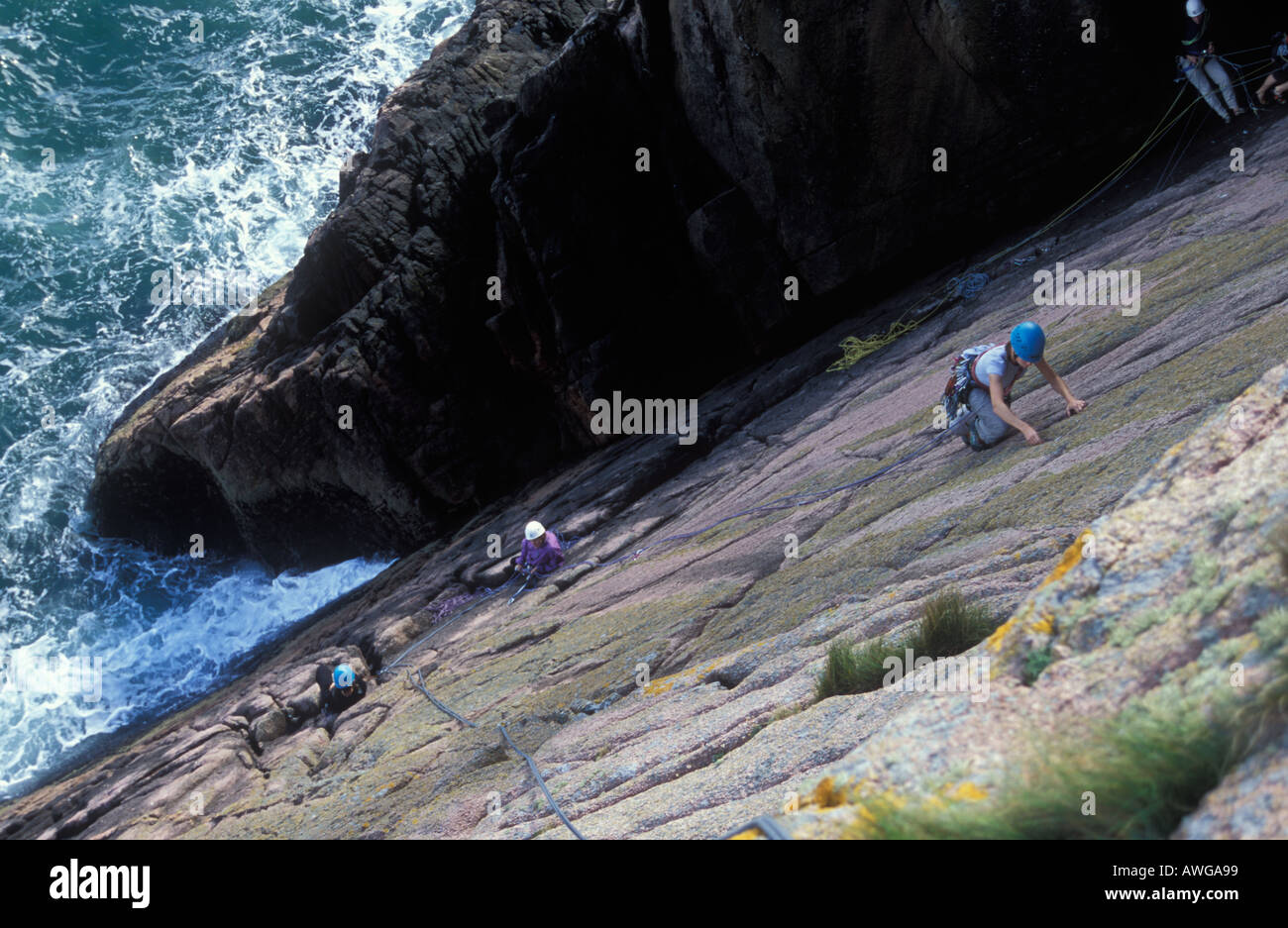 Climbing at Fulmar Wall near Slains Castle NE of Aberdeen Stock Photo