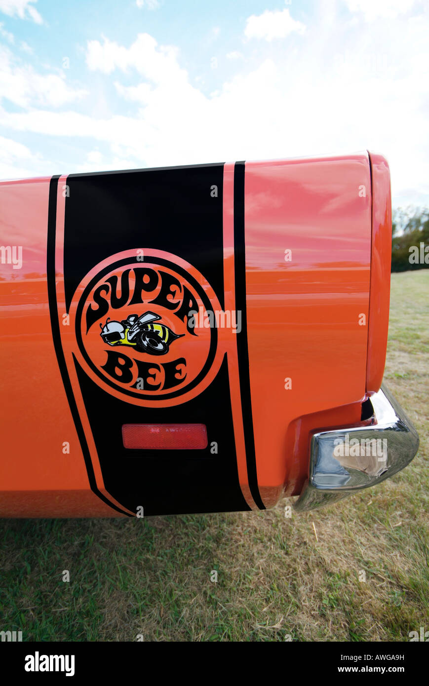 Side shot of the logo for an orange 1969 Dodge Superbee ,mid