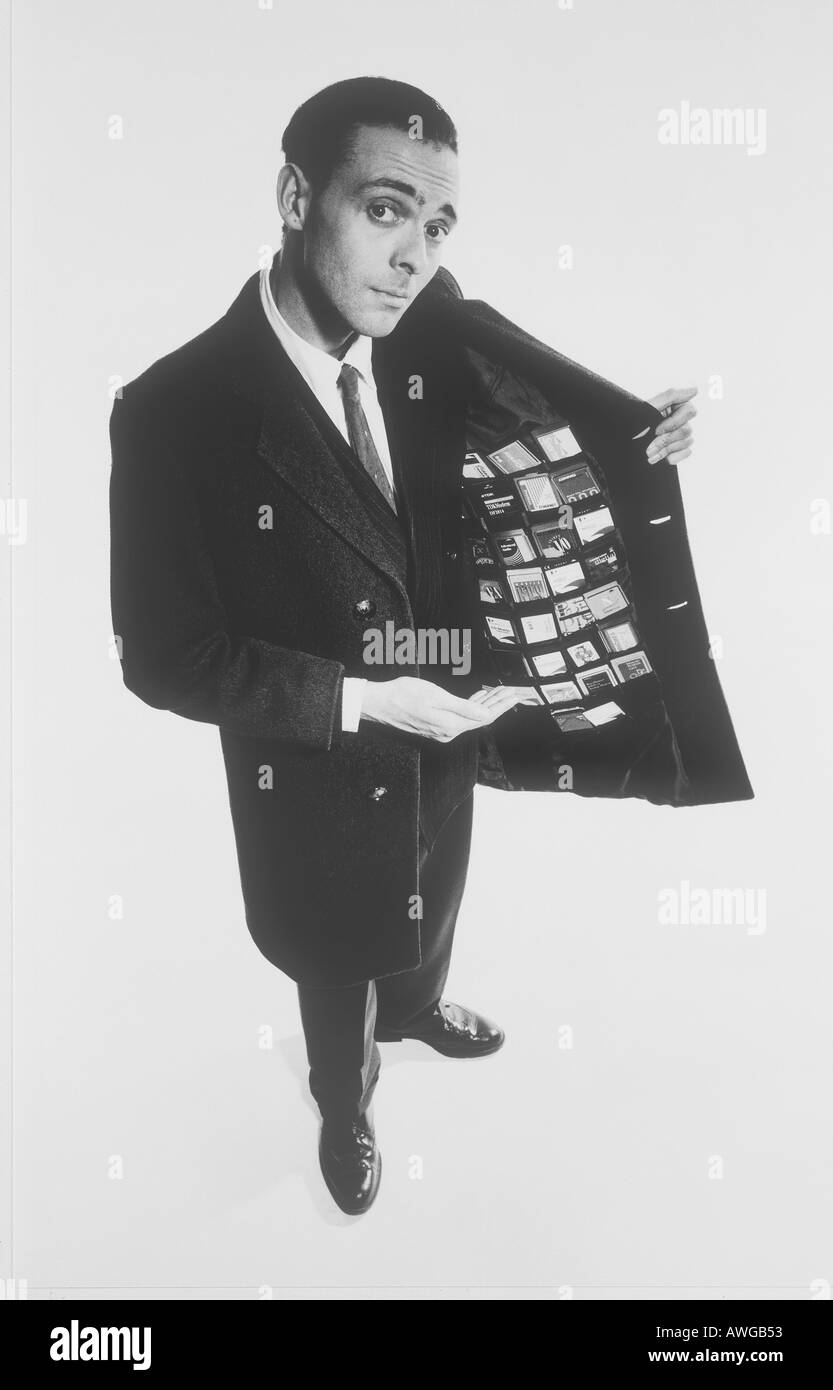 A man holding his jacket open showing many business credit cards Stock Photo