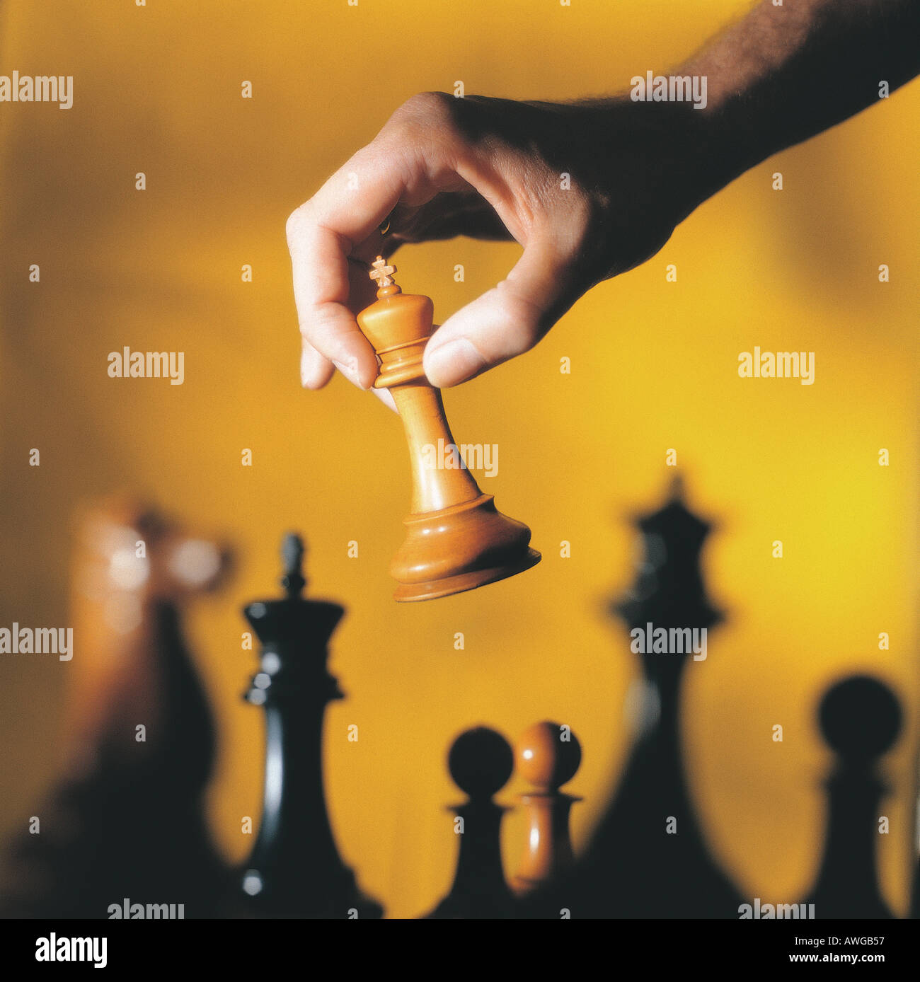 A hand holding a chess piece Stock Photo