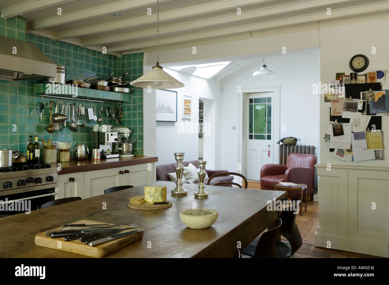 Open plan kitchen with turquoise tiles and beamed ceiling Stock Photo