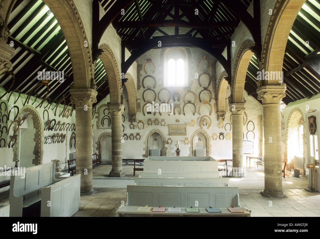 Oakham Castle interior Rutland Leicestershire horseshoes collection Norman Romanesque architecture history historic arches Stock Photo