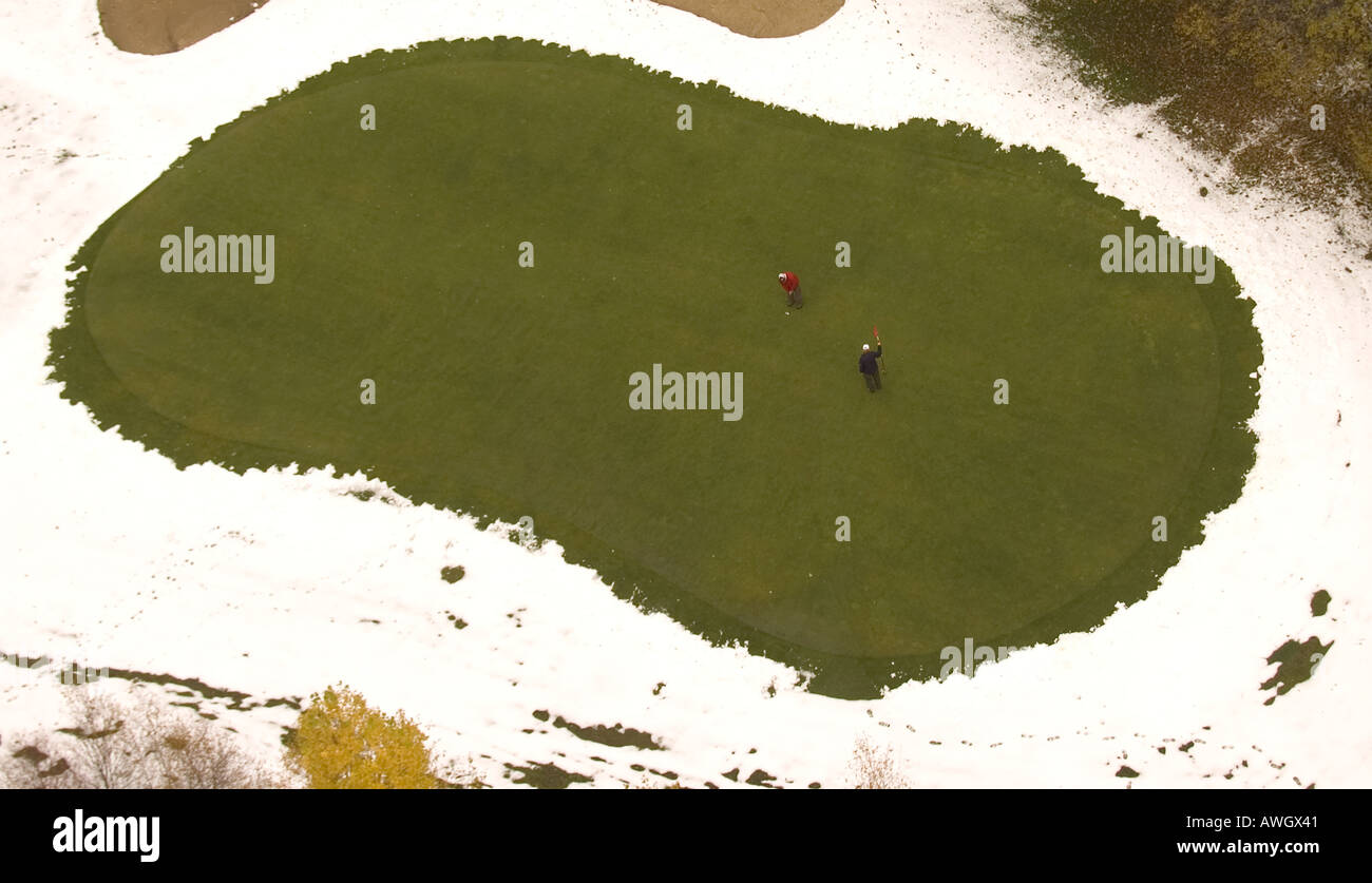 With snow shoveled away from the green, diehard golfers put at the