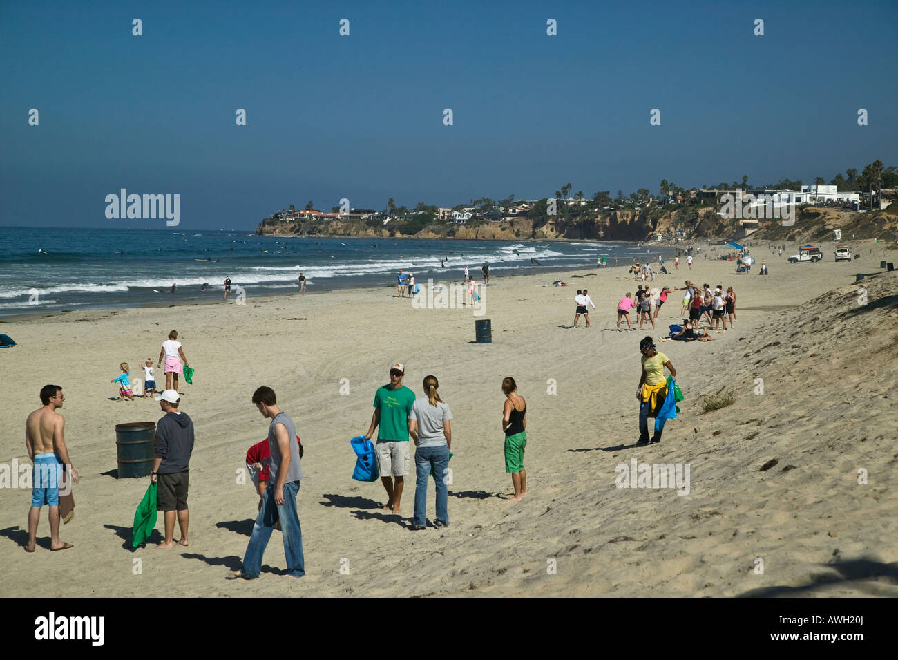 People on beach cleanup day Pacific Beach Tourmaline Surfing Beach Park, San Diego, California, USA Stock Photo