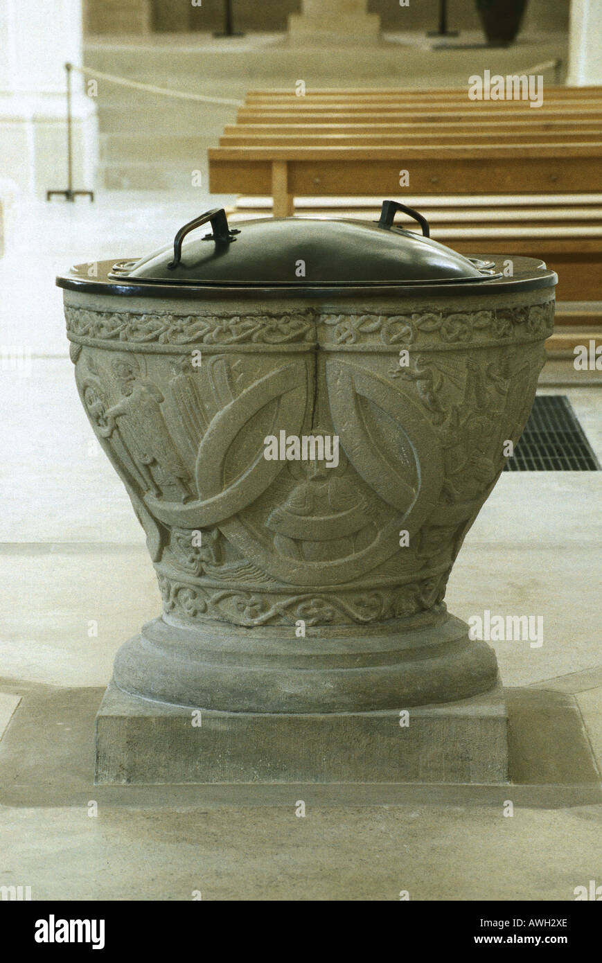 Germany, Upper Bavaria (South), Altenstadt, Michaelskirche, stone font with metal lid in Romanesque basilica Stock Photo