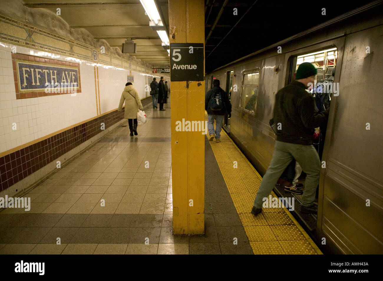 A man enters a subway car on a New York City subway station on Fifth ...