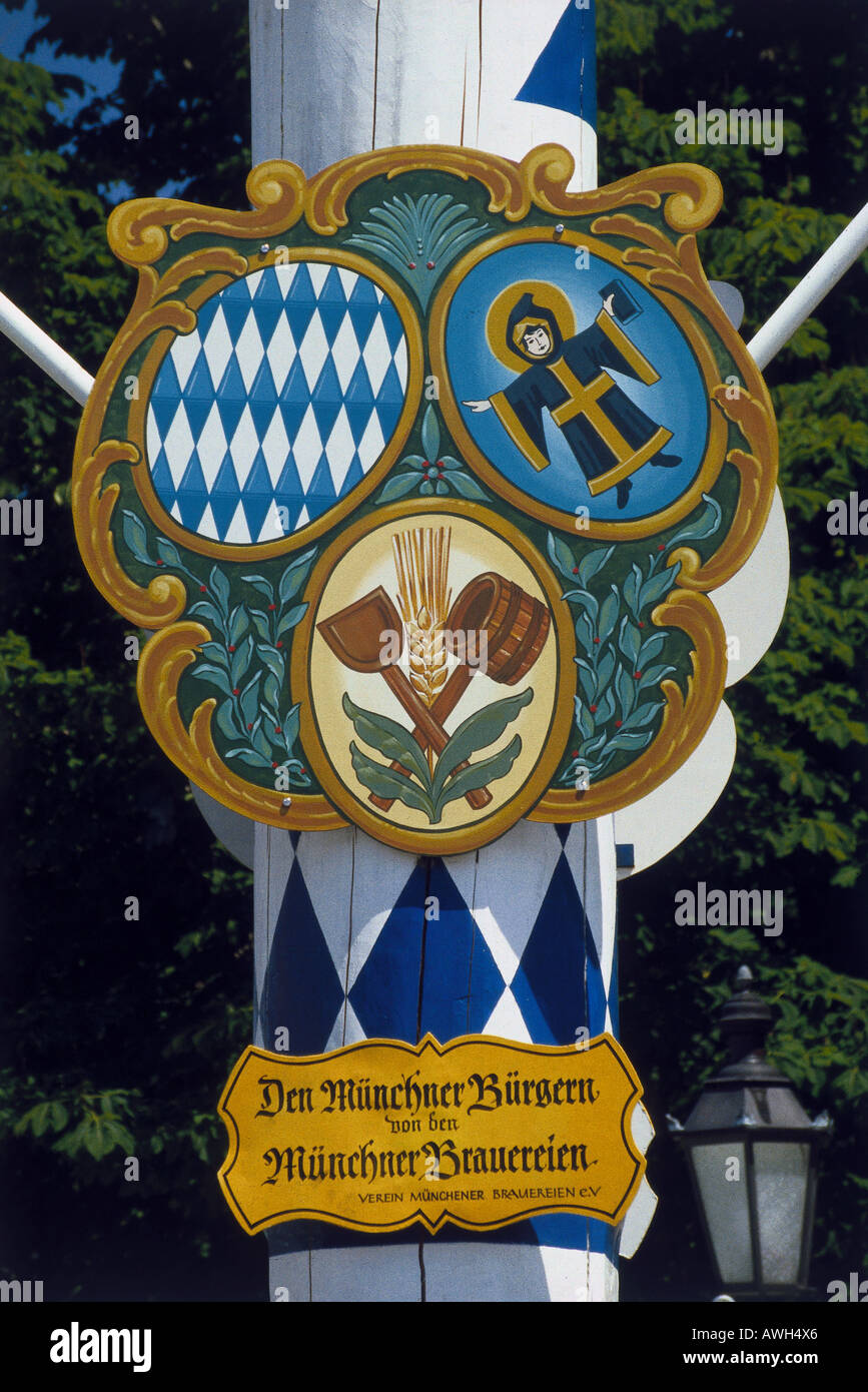 Germany, Bavarian Alps, coats of arms on maypole, painted in Bavarian colours, of Verein Münchener Brauereien e.V. Stock Photo