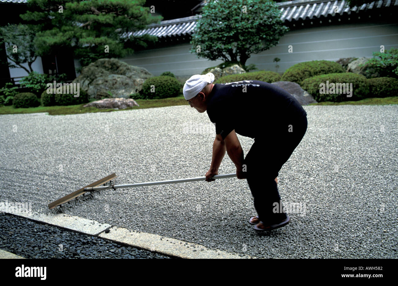 Buddhist monk raking the Zen garden of Nanzen ji Temple Kyoto Japan ...