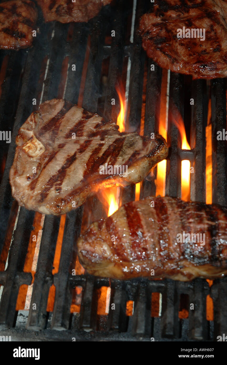 Prime steaks cooking on an open grill dsc 7716 Stock Photo Alamy