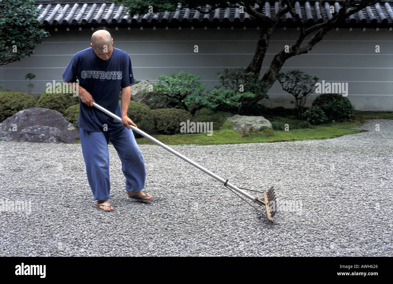 Buddhist monk raking the Zen garden of Nanzen ji Temple Kyoto Japan ...