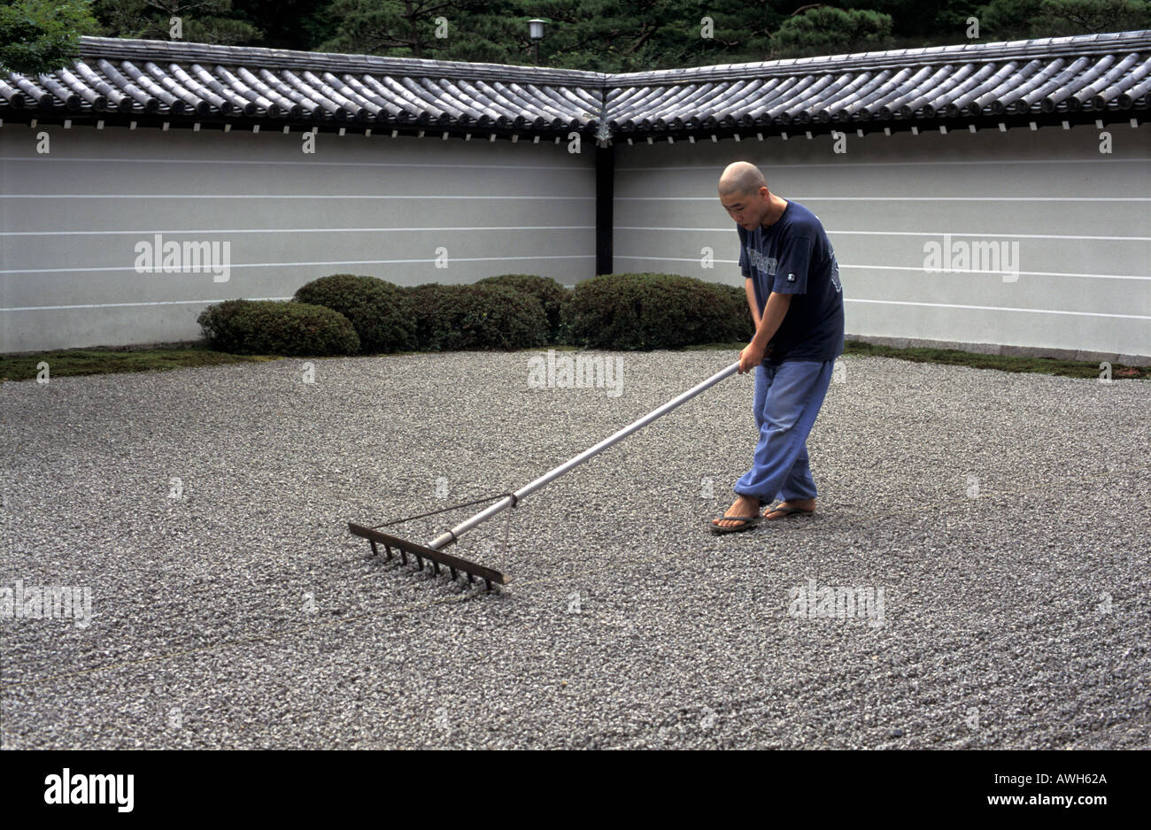 Buddhist monk raking the Zen garden of Nanzen ji Temple Kyoto Japan ...