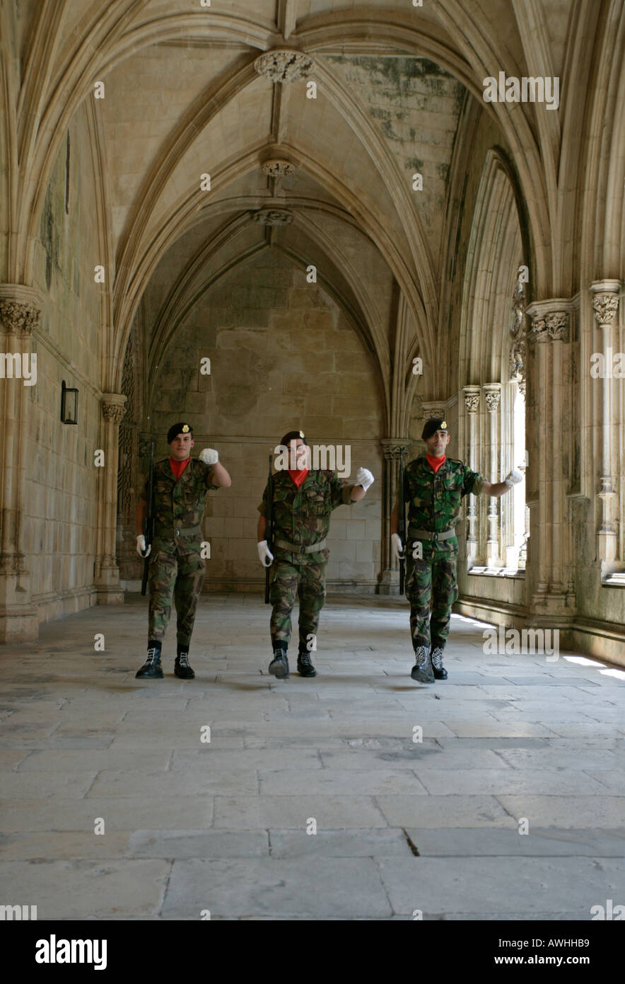 An honor guard of soldiers march in the tomb of the unknown soldier at the ornate Cloister of King João I (Claustro Real) Stock Photo