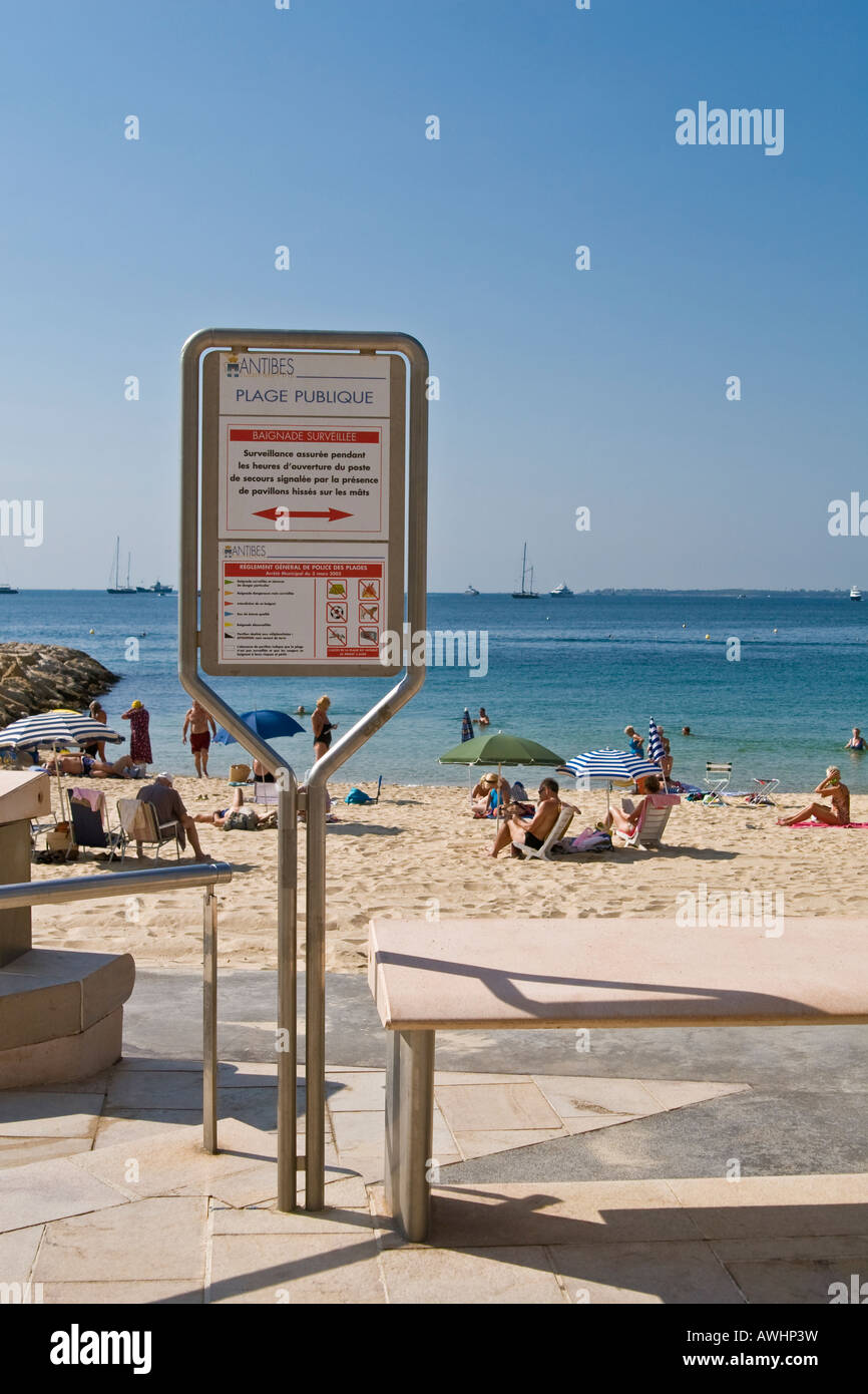 Antibes (Juan les Pins) public beach rules, people on the beach Stock Photo  - Alamy