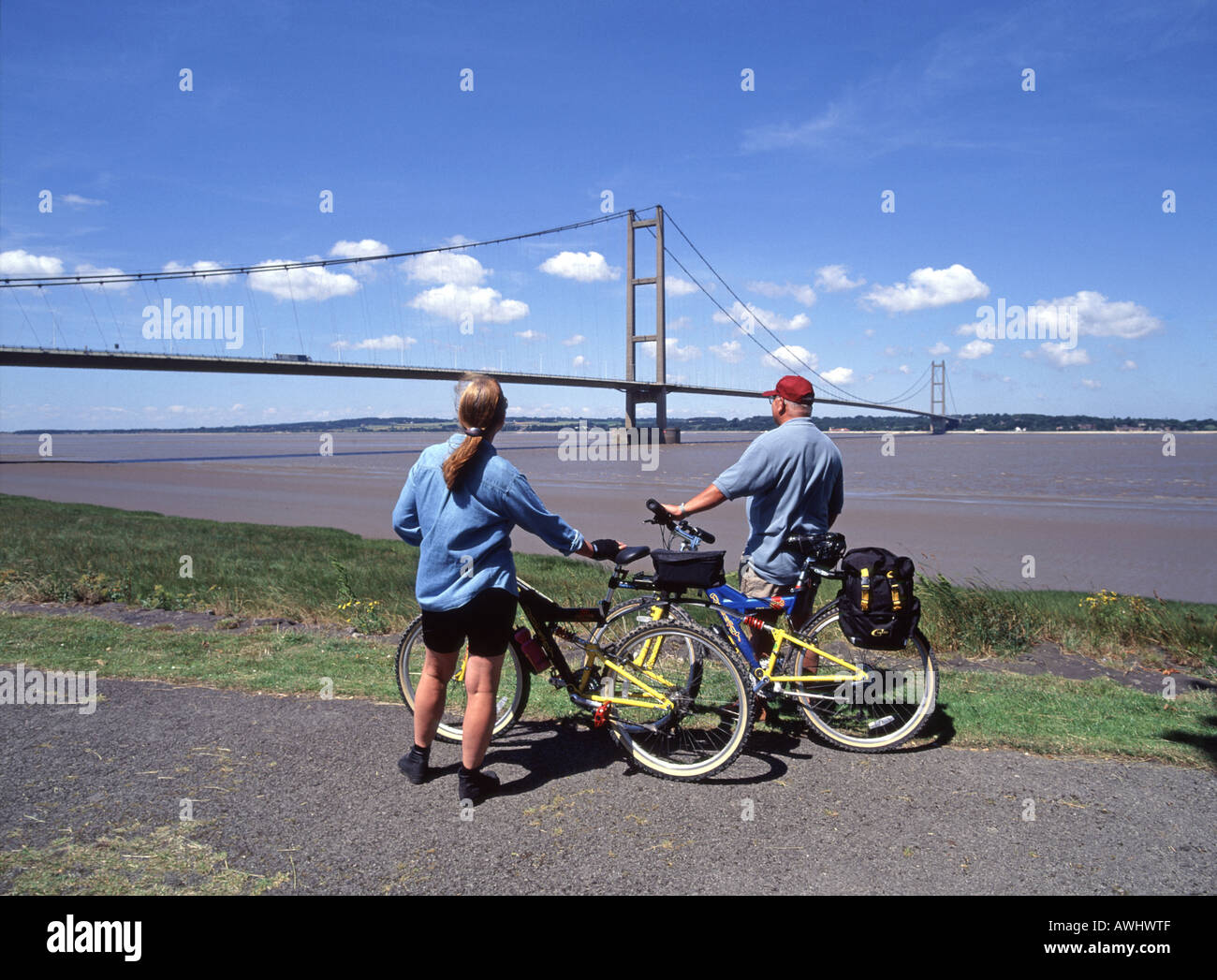 Cycling beside Landmark A15 road Humber suspension bridge spans humber estuary from Barton upon Humber Lincolnshire towards East Riding of Yorkshire Stock Photo