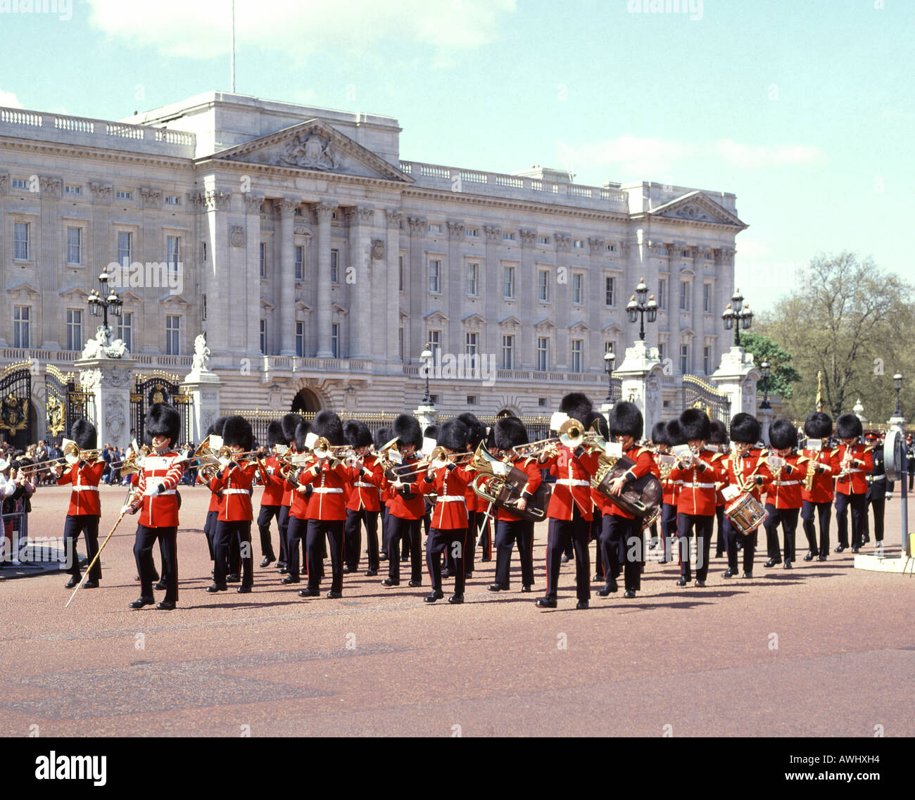 Buckingham Palace British soldier in guard regiment musicians marching & playing musical instruments changing guard ceremony Iconic London England UK Stock Photo