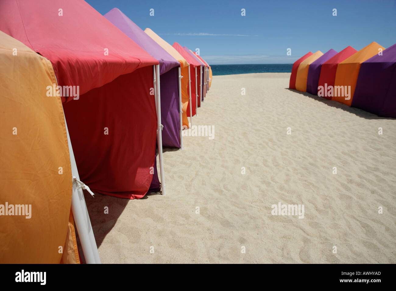 Seasonal cabanas on the wide beaches at the coastal resort town of Nazaré on Portugal s Atlantic seaboard Stock Photo