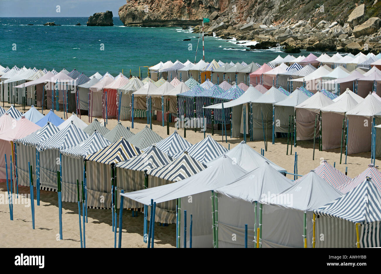 Seasonal cabanas on the wide beaches at the coastal resort town of Nazaré on Portugal's Atlantic seaboard Stock Photo