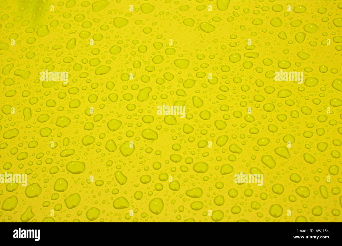 Water droplets on yellow background abstract Stock Photo - Alamy