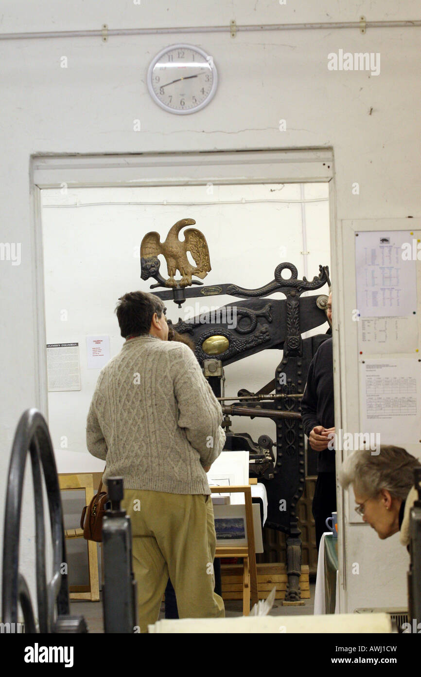 A vintage hand printing press is visible through a door Stock Photo Alamy