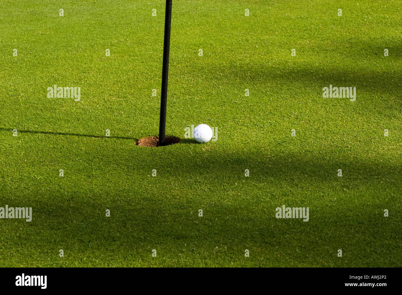 Side View of Golf ball and Hole golf golfing game sport leisure pastime