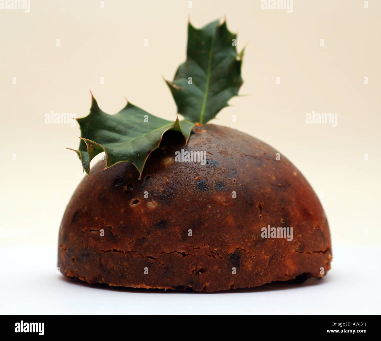 Christmas pudding with holly on white background in studio Stock Photo